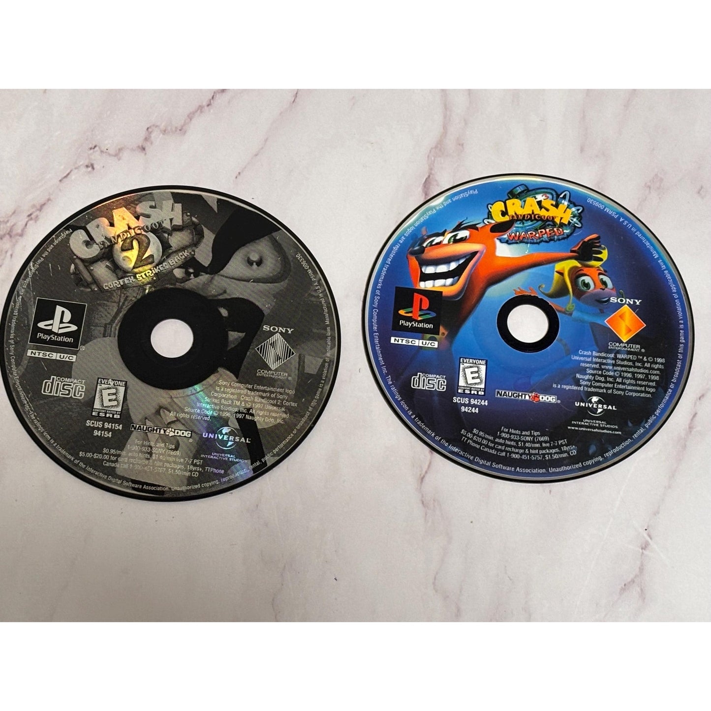 Lot of 2 Play Station 1 PS1 Crash Bandicoot Games Warped Cortex Strikes Back 2